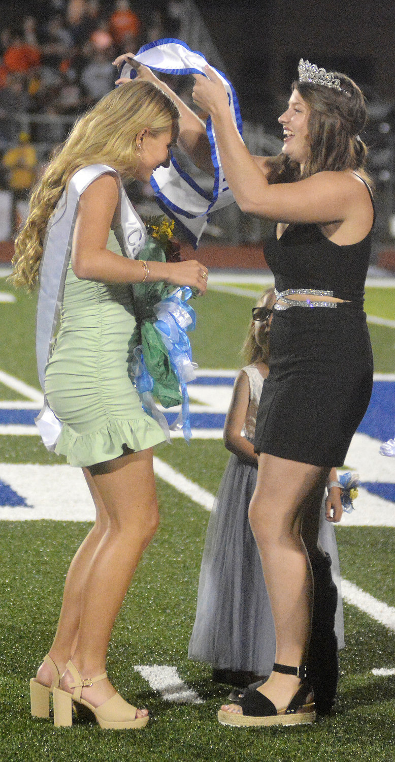 Hermann High School senior queen candidates and underclassmen attendants were escorted by their fathers Friday for homecoming coronation festivities at halftime of the Bearcats’ Four Rivers Conference football game against the Owensville Dutchmen. Morgan Miller, escorted by her father Ryan Miller, was crowned queen (left) by retiring queen Zoe Schafer.